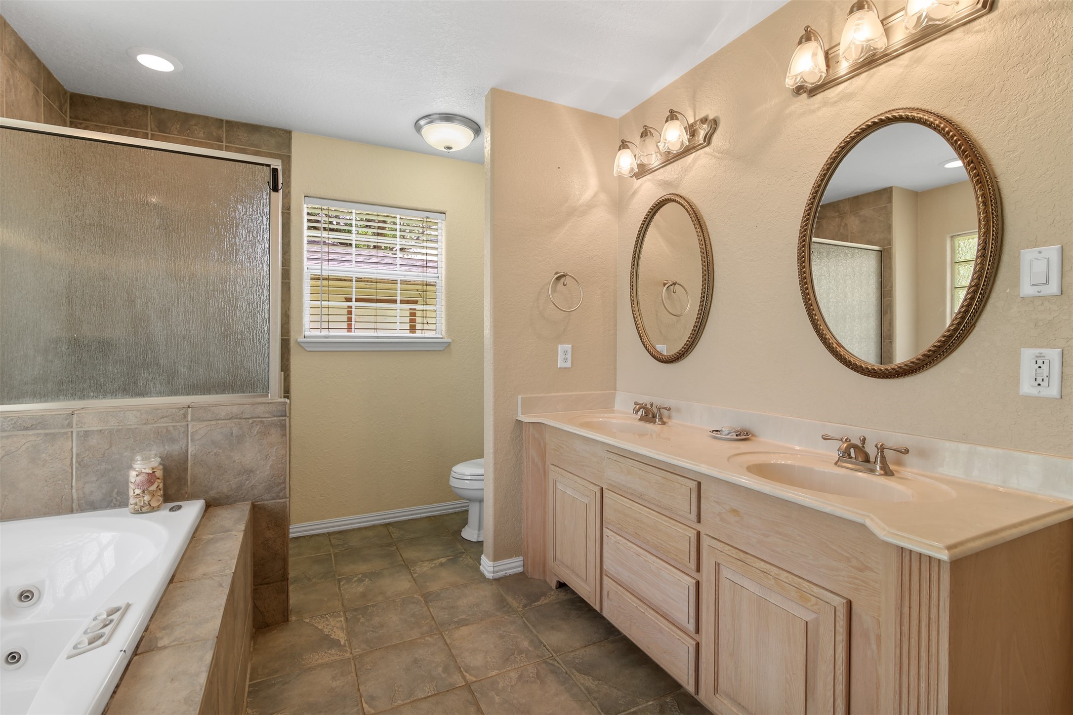 11692 Clark Lane Conroe, TX 77385 - Photo 13 of 35 The primary bathroom also features double sinks and ample under counter storage space.
