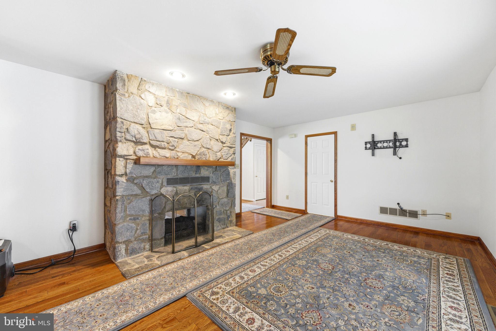 736 Letitia Drive Hockessin, DE 19707 - Photo 32 of 92 a view of a livingroom with a fireplace and wooden floor