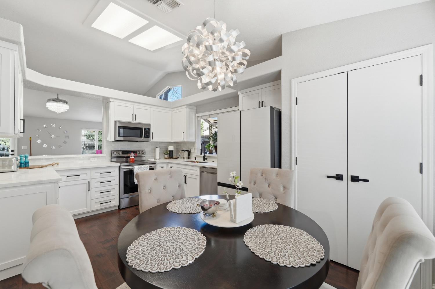 3409 Friar Tuck Way Modesto, CA 95355 - Photo 13 of 46 a large kitchen with sink refrigerator dining table and chairs
