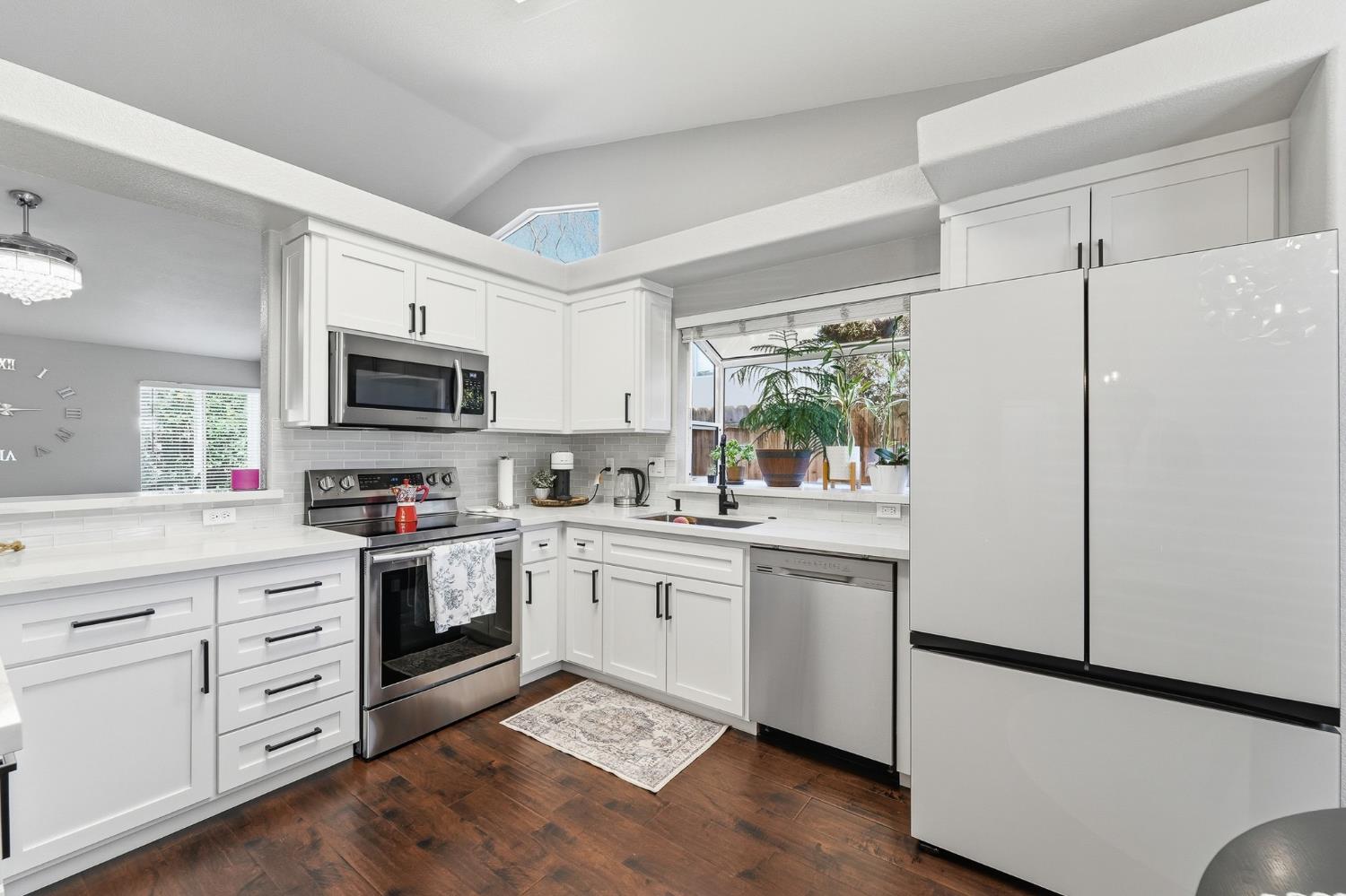 3409 Friar Tuck Way Modesto, CA 95355 - Photo 14 of 46 a kitchen with white cabinets and white appliances