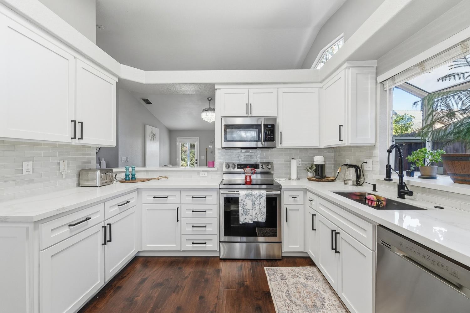 3409 Friar Tuck Way Modesto, CA 95355 - Photo 17 of 46 a kitchen with white cabinets appliances and a sink