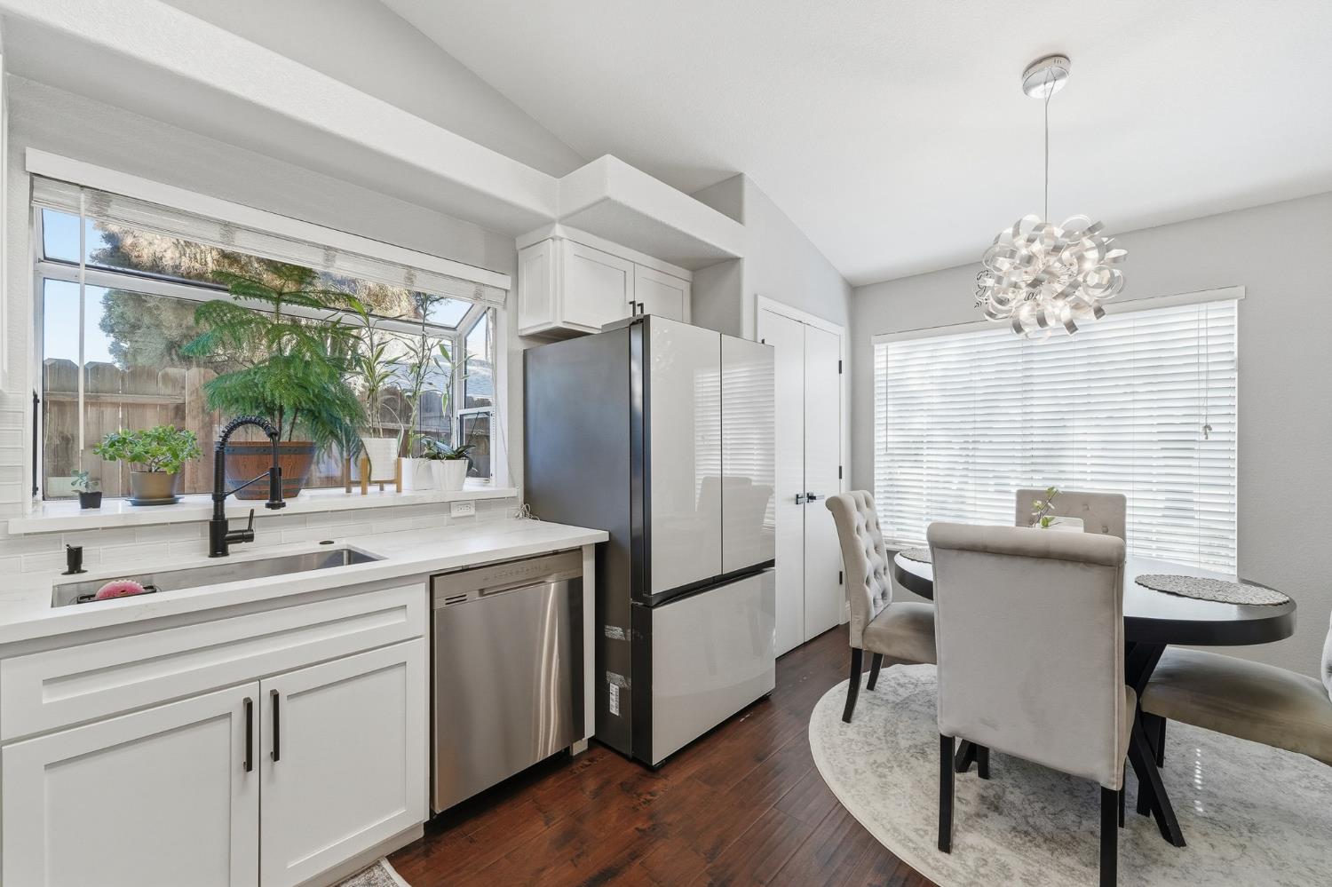 3409 Friar Tuck Way Modesto, CA 95355 - Photo 19 of 46 a kitchen with a table chairs refrigerator and sink