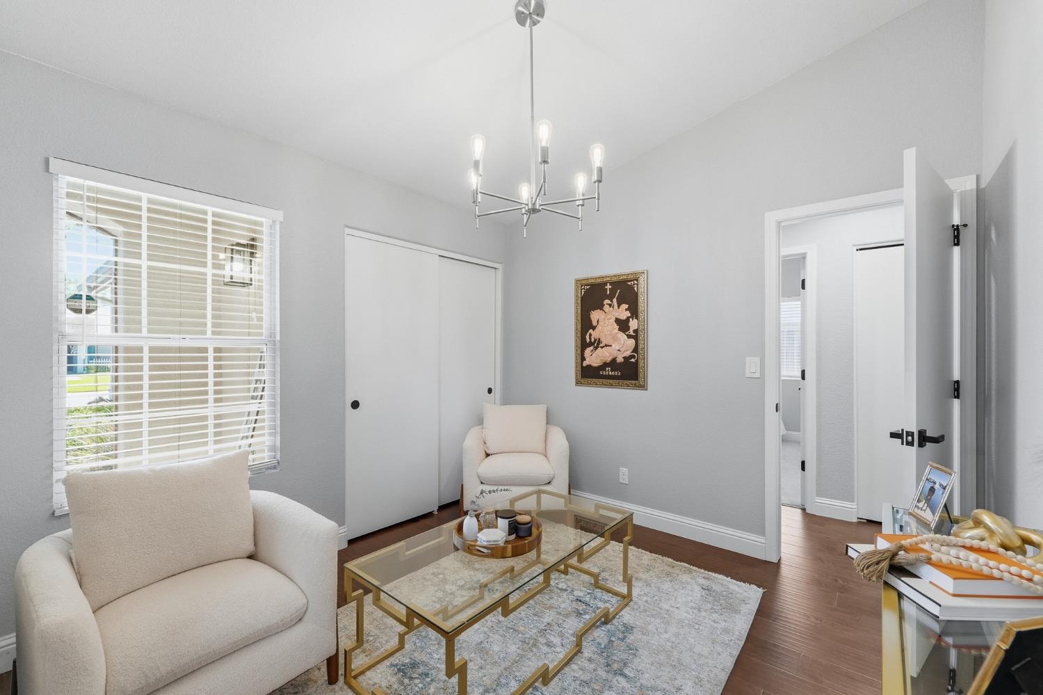 3409 Friar Tuck Way Modesto, CA 95355 - Photo 20 of 46 a living room with furniture a window and a chandelier