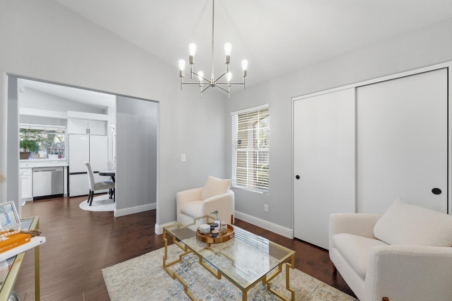 3409 Friar Tuck Way Modesto, CA 95355 - Photo 21 of 46 a living room with furniture a table and wooden floor