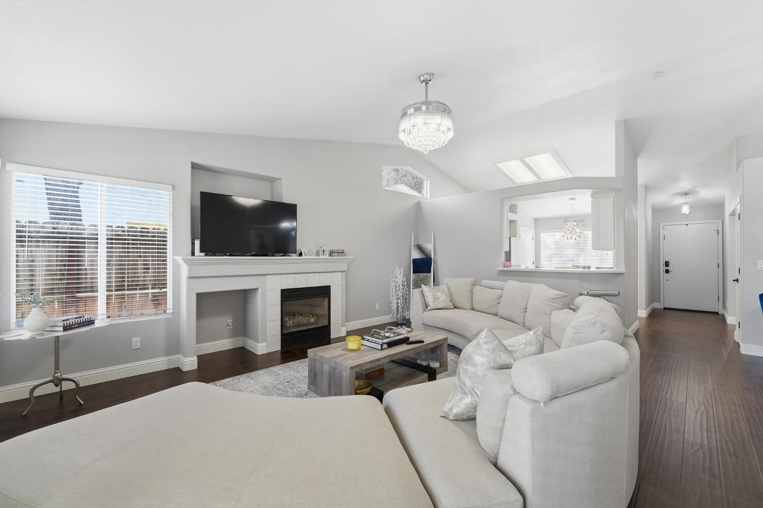 3409 Friar Tuck Way Modesto, CA 95355 - Photo 24 of 46 a living room with furniture a fireplace and a flat screen tv