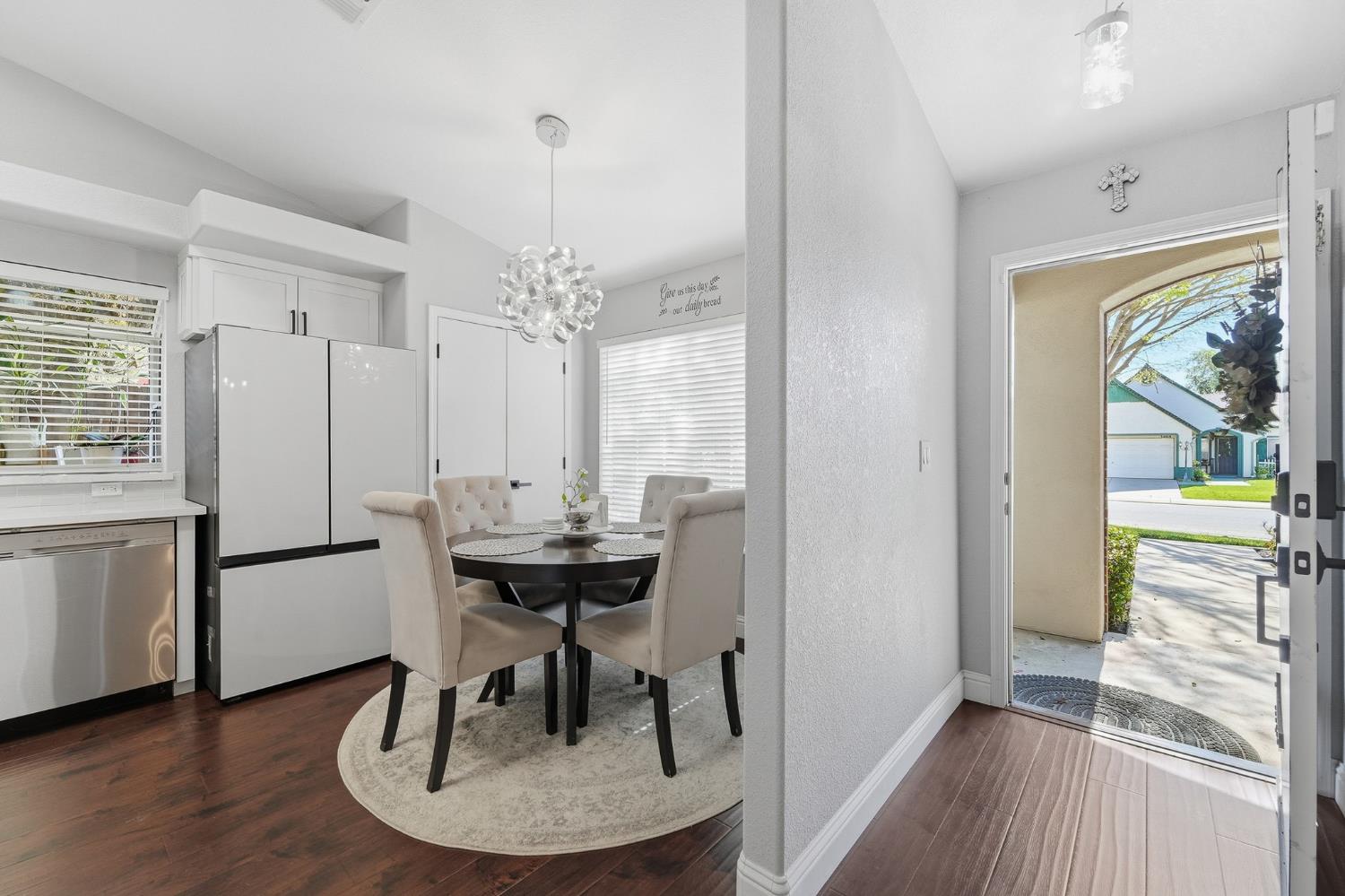 3409 Friar Tuck Way Modesto, CA 95355 - Photo 8 of 46 a dining room with furniture a chandelier and wooden floor