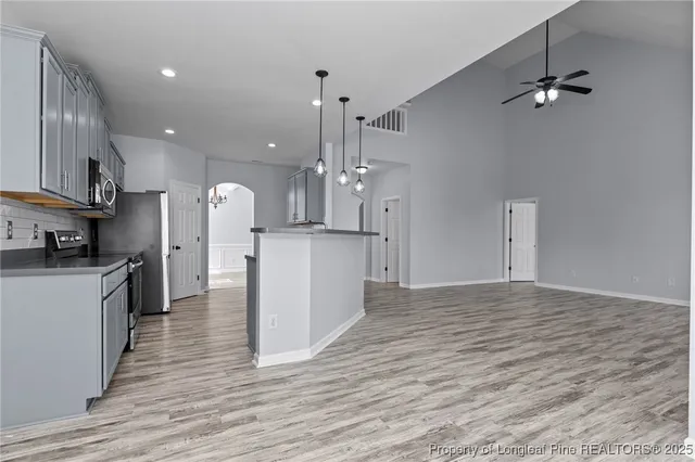 a view of a kitchen with a sink a refrigerator and a stove