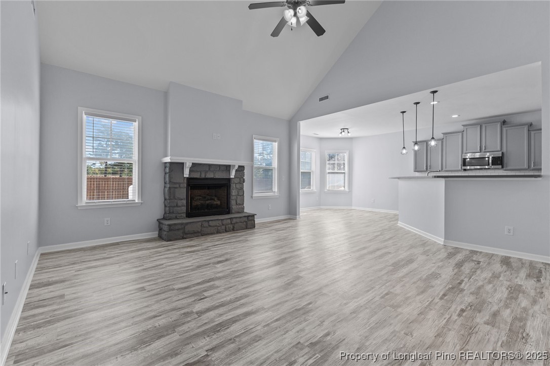 12 Turnbridge Way Spring Lake, NC 28390 - Photo 16 of 46 an empty room with wooden floor kitchen view and a window