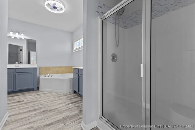 a bathroom with a shower a sink and a mirror