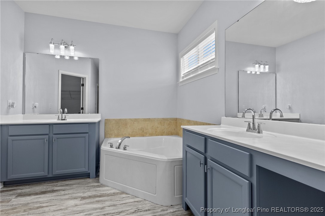 12 Turnbridge Way Spring Lake, NC 28390 - Photo 20 of 46 a bathroom with a tub a sink and mirror