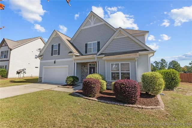 a view of a house with backyard and porch