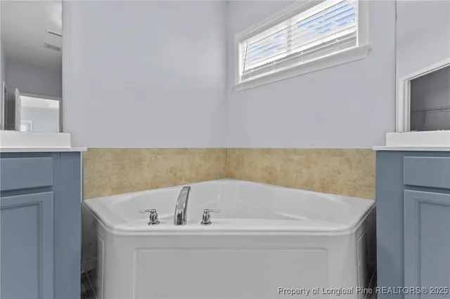 a white bath tub sitting in a bathroom