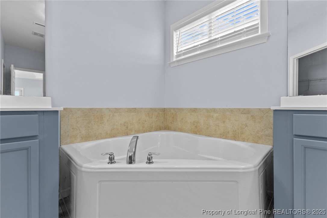 12 Turnbridge Way Spring Lake, NC 28390 - Photo 21 of 46 a white bath tub sitting in a bathroom