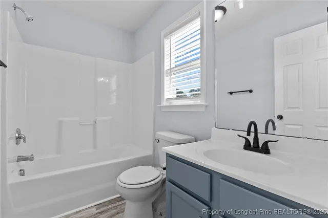 a bathroom with a sink a toilet and bathtub