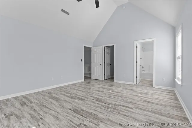 a view of an empty room with wooden floor