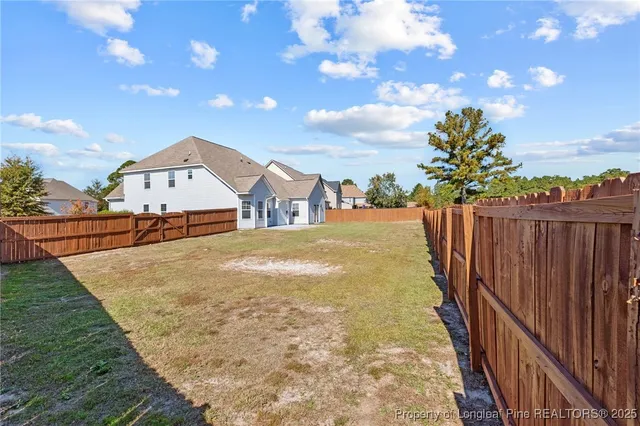 a view of a house with backyard