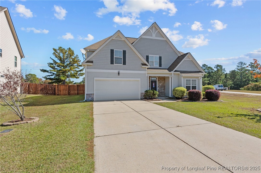 12 Turnbridge Way Spring Lake, NC 28390 - Photo 41 of 46 a front view of a house with a yard and garage