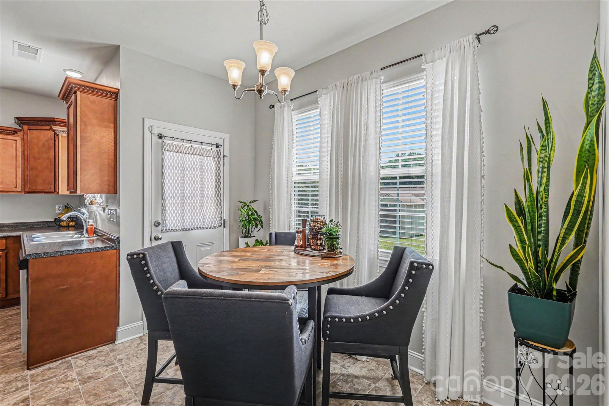1610 Walter Hasty Road Monroe, NC 28110 - Photo 12 of 32 a dining room with furniture potted plants and wooden floor