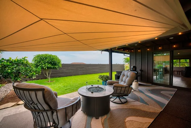 a view of a patio with a table chairs and a patio