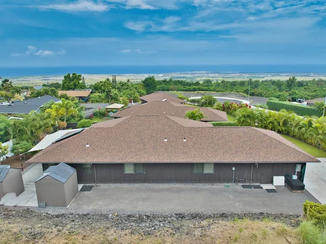 an aerial view of a house with a yard and lake view