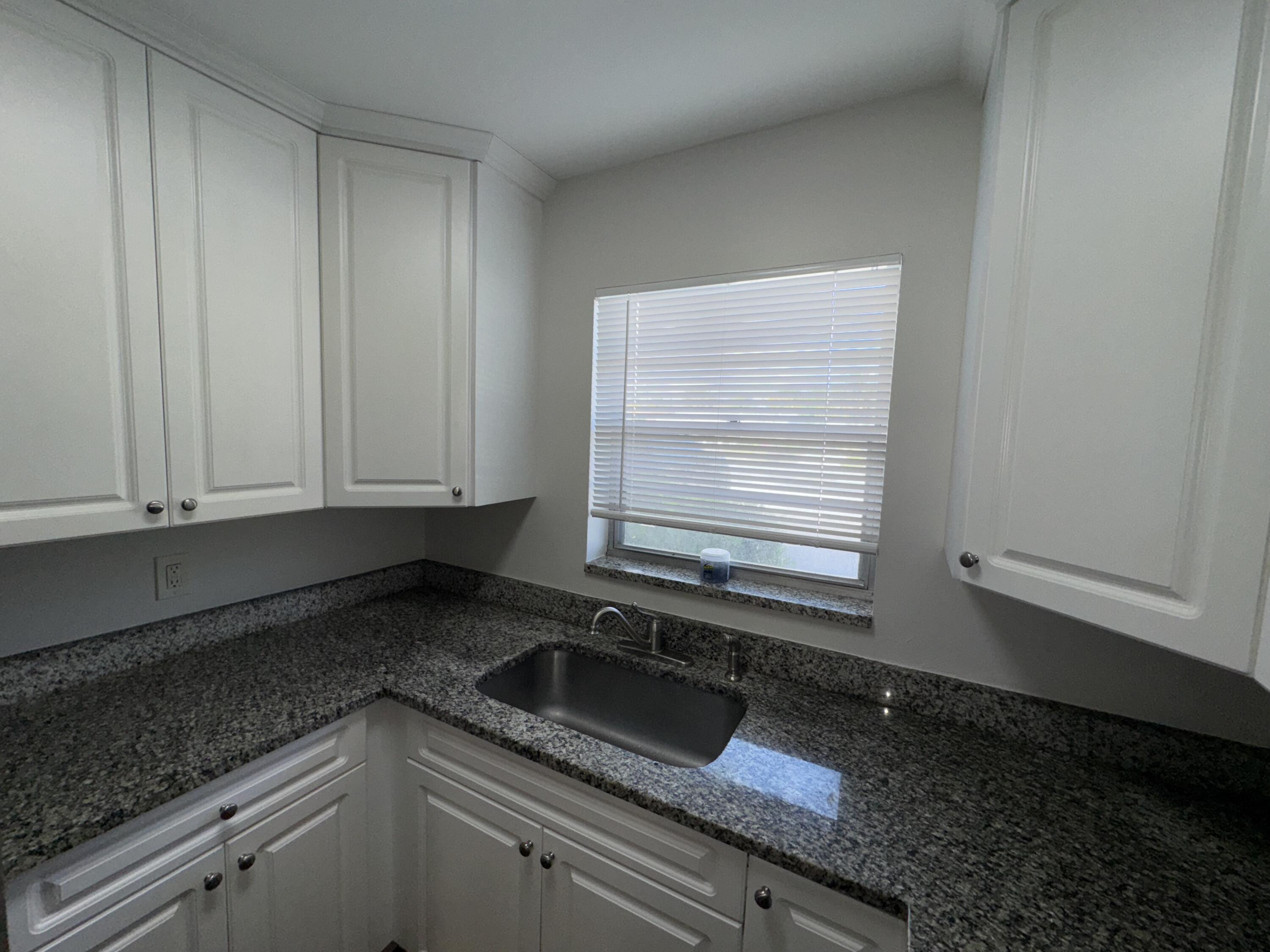 420 West Palm Street, Unit 4 Lantana, FL 33462 - Photo 3 of 21 a kitchen with granite countertop white cabinets and sink