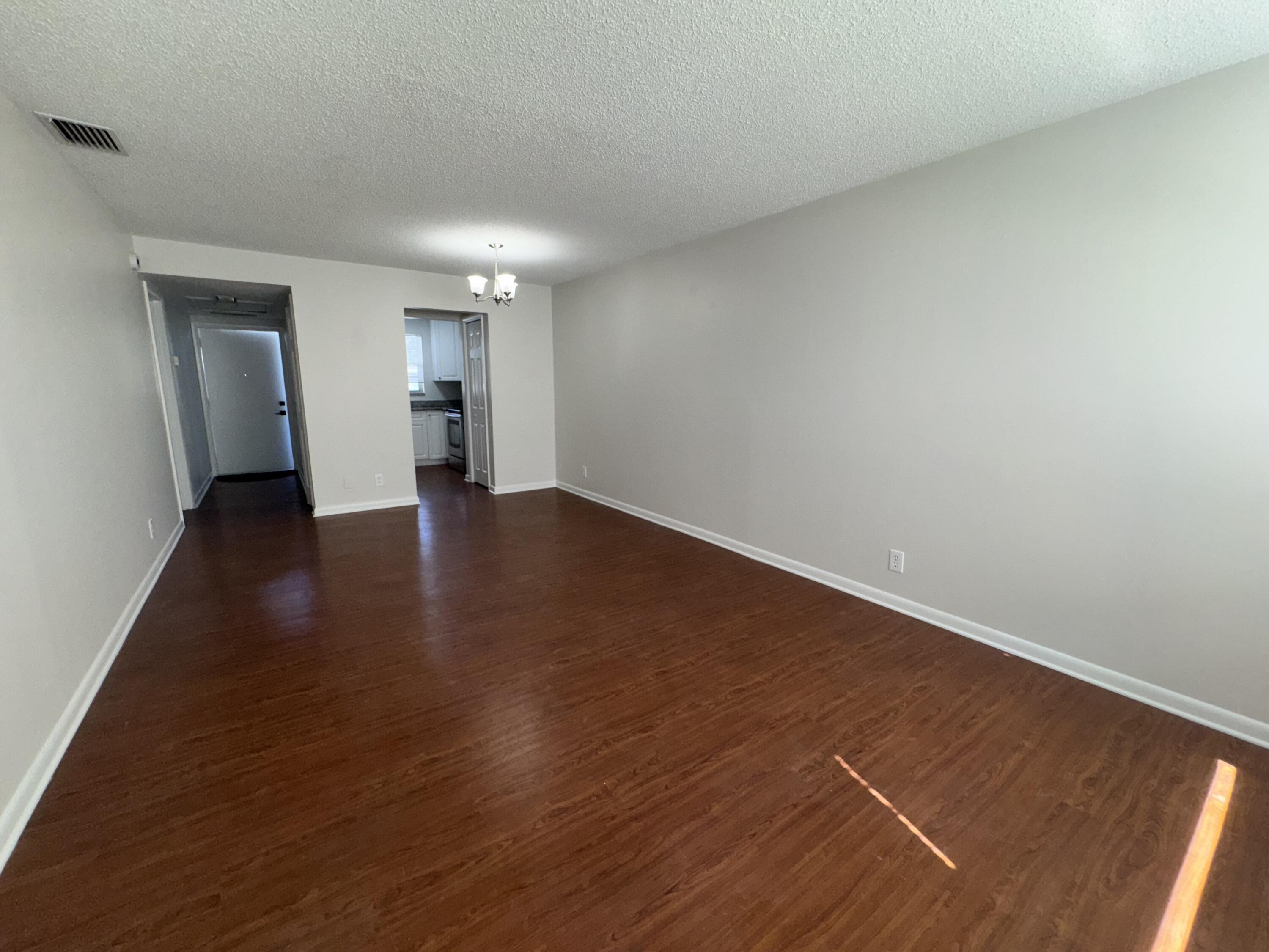 420 West Palm Street, Unit 4 Lantana, FL 33462 - Photo 6 of 21 a view of an empty room with wooden floor and a window