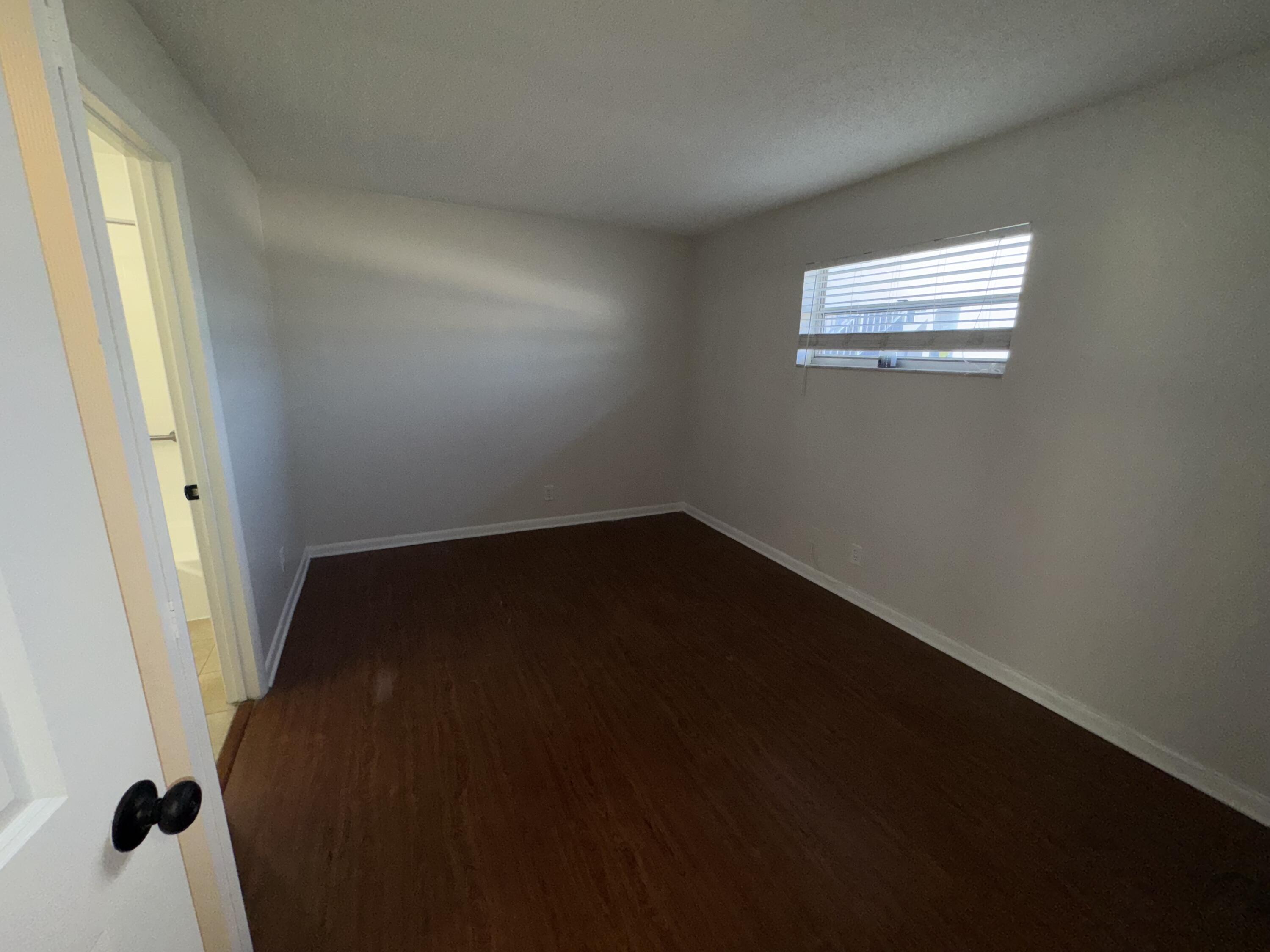 420 West Palm Street, Unit 4 Lantana, FL 33462 - Photo 8 of 21 an empty room with wooden floor and windows