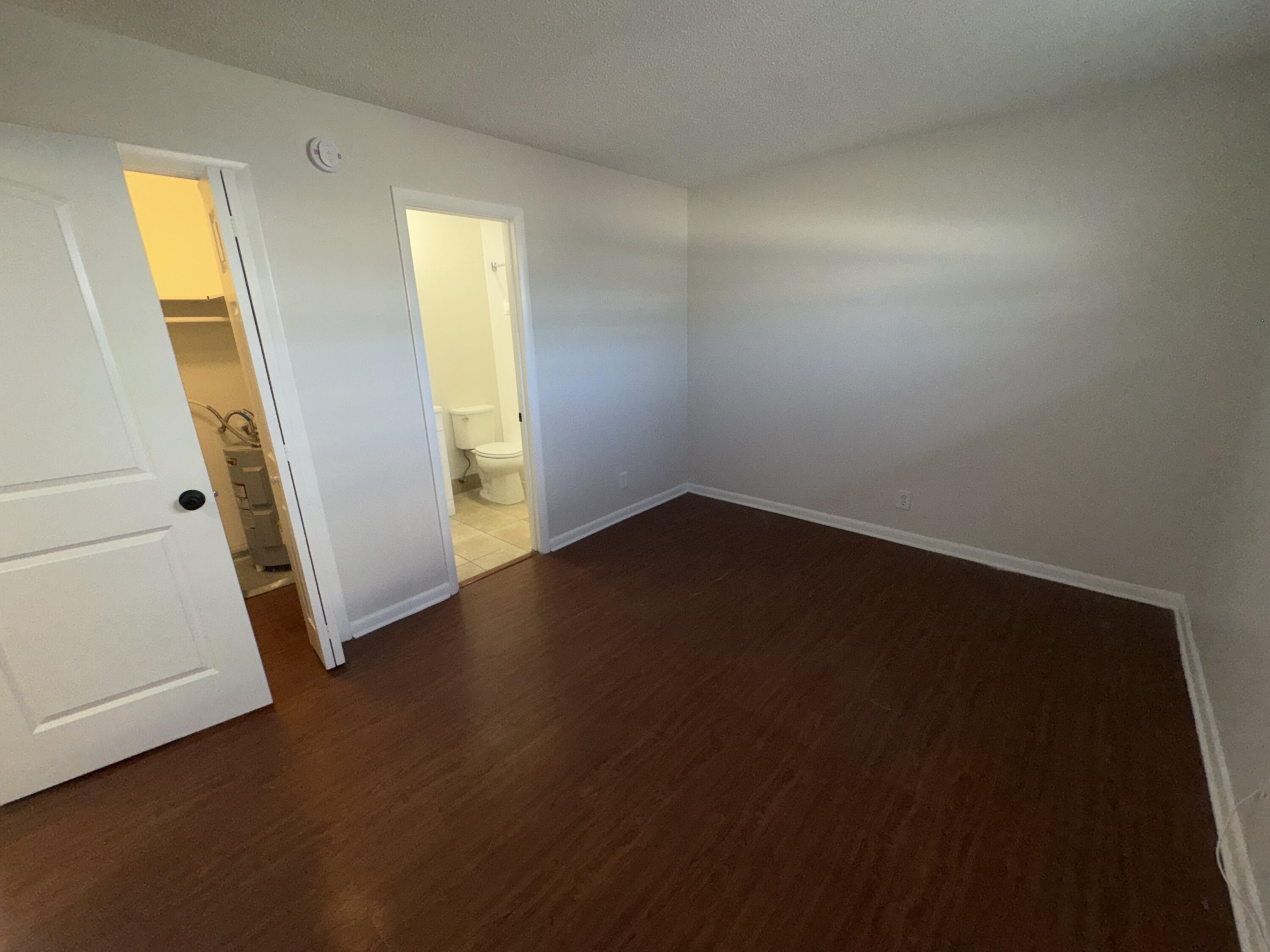 420 West Palm Street, Unit 4 Lantana, FL 33462 - Photo 9 of 21 an empty room with wooden floor and windows