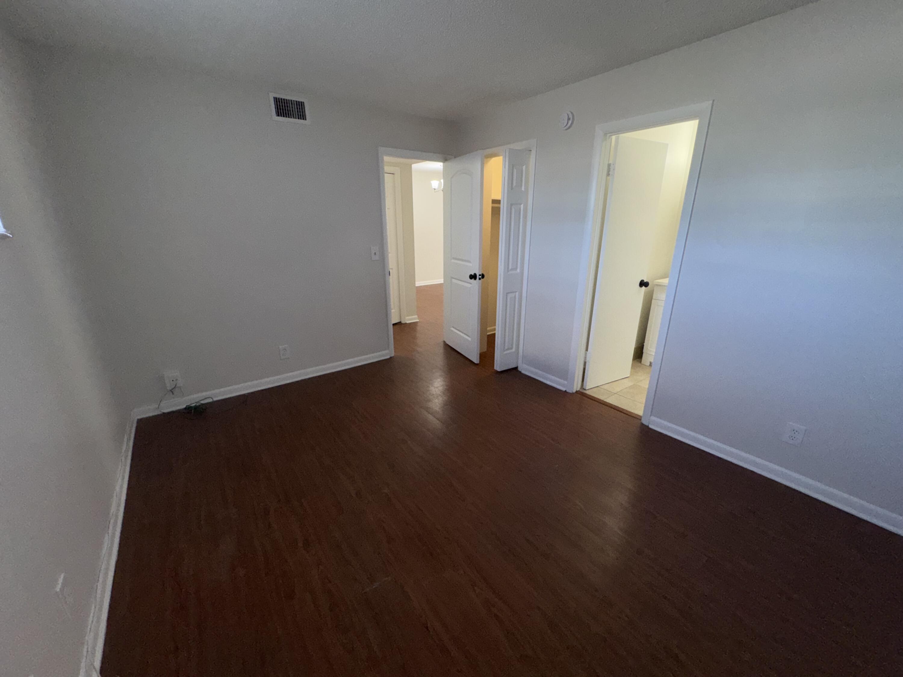 420 West Palm Street, Unit 4 Lantana, FL 33462 - Photo 10 of 21 an empty room with wooden floor and windows