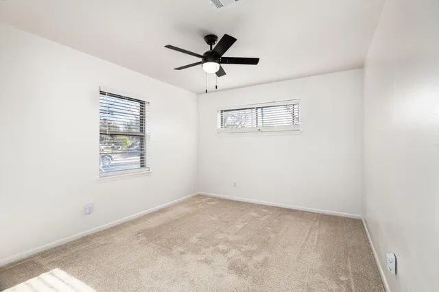 a view of room with window and ceiling fan