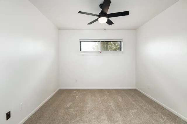 an empty room with a fan
