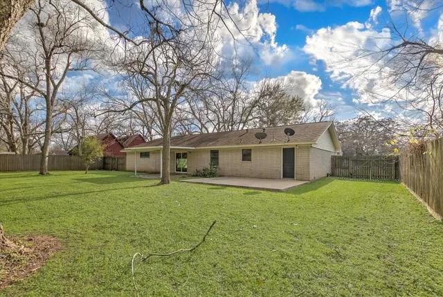 a house that has a tree in front of it