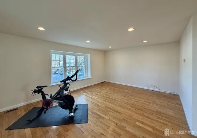 a view of a room with gym equipment and a window