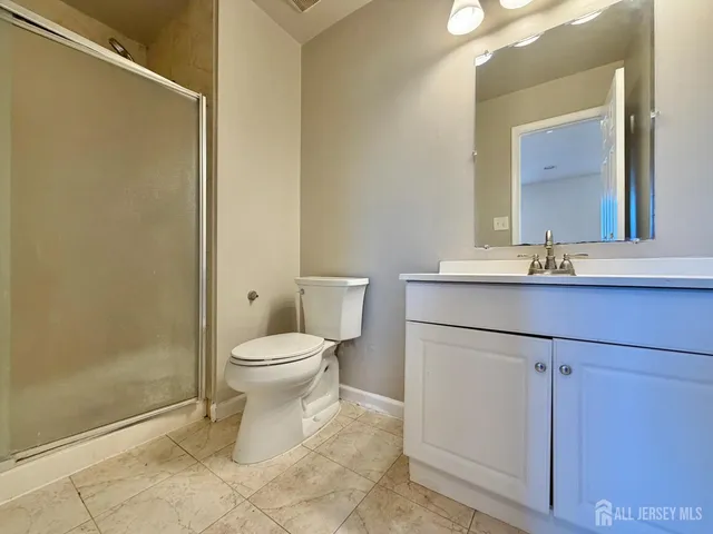 a bathroom with a toilet a sink and a mirror