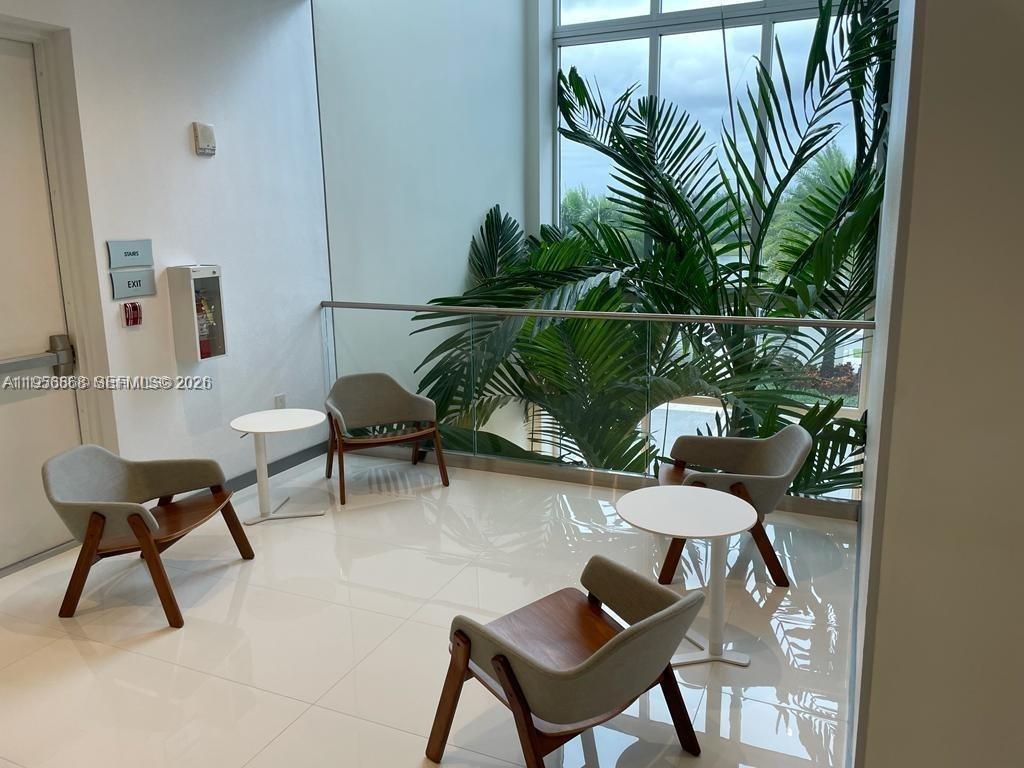 6453 Northwest 102nd Path, Unit 303 Doral, FL 33178 - Photo 26 of 39 a living room with furniture and a potted plant
