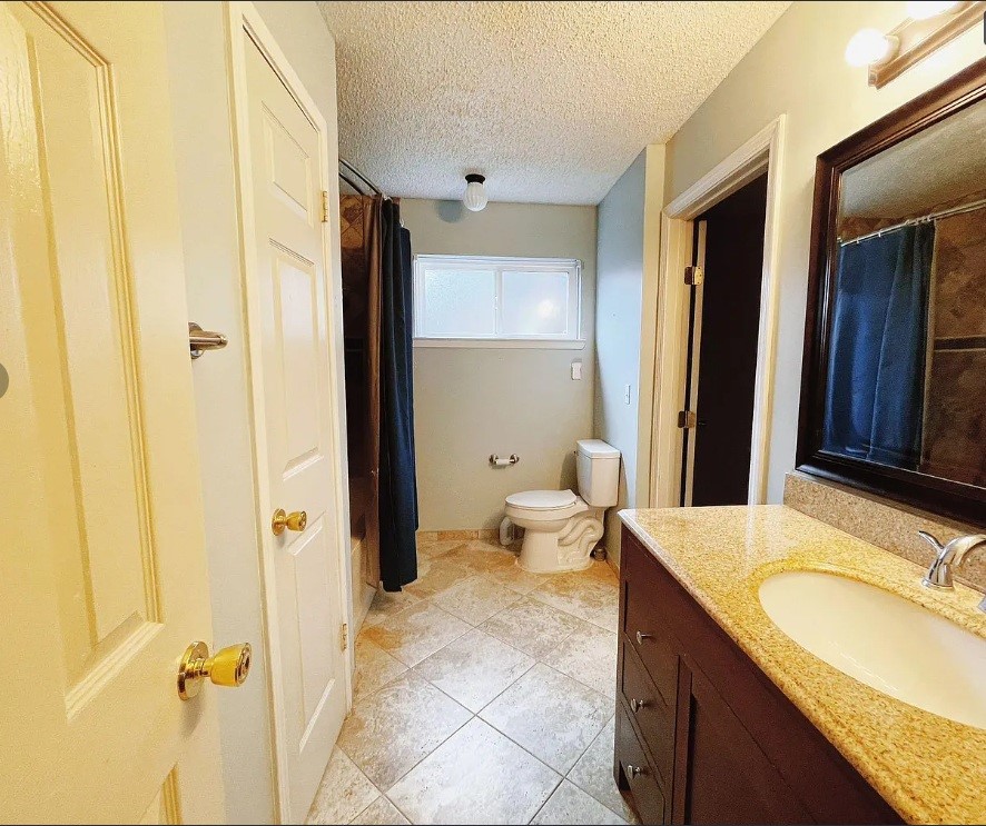1906 Woodstream Boulevard Sugar Land, TX 77479 - Photo 12 of 14 a bathroom with a granite countertop sink and a mirror