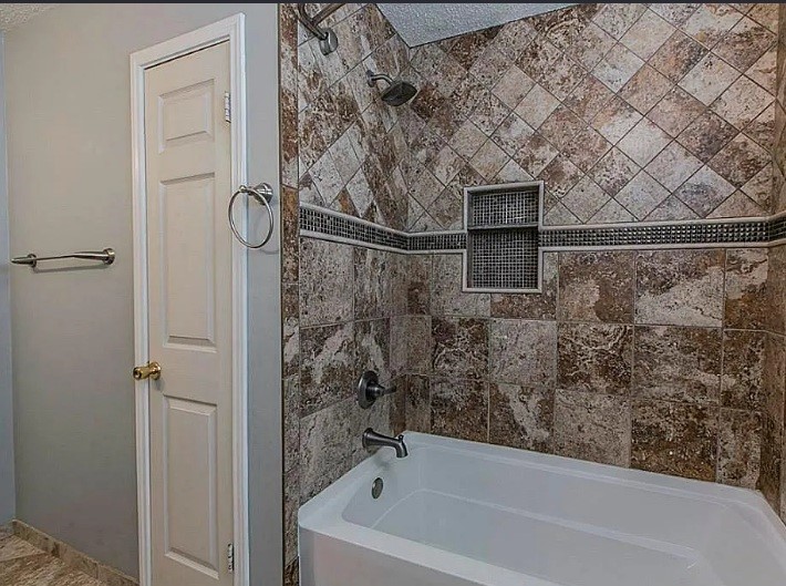 1906 Woodstream Boulevard Sugar Land, TX 77479 - Photo 13 of 14 a bathroom with a bathtub