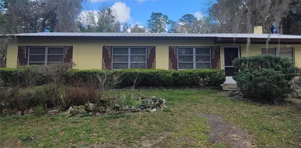 a view of a house with a yard and plants