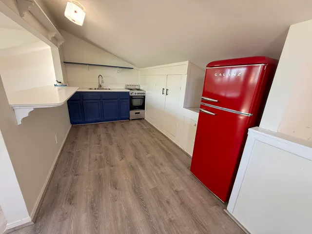 a view of a kitchen with wooden floor