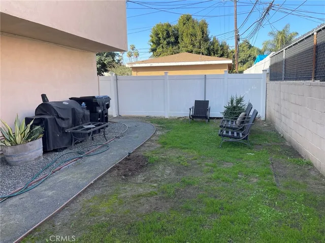 a backyard of a house with table and chairs