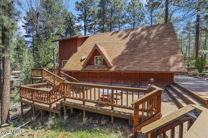 8884 Tonto Rim Drive Pine, AZ 85544 - Photo 5 of 43 a view of a roof deck with two chairs and wooden fence