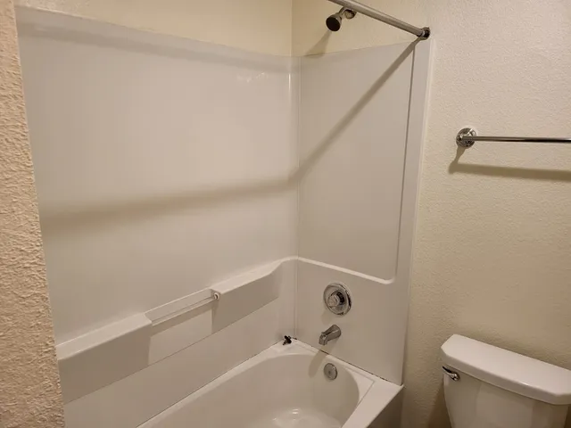 a white toilet sitting next to a white sink