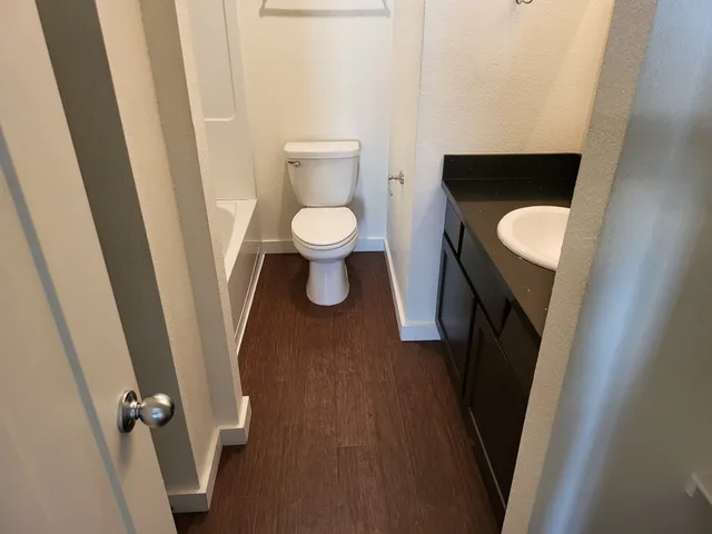 a view of a room with wooden floor and small space