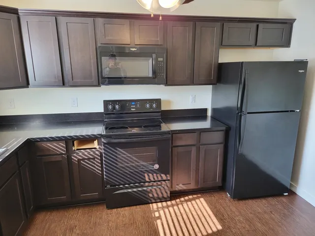 a kitchen with a refrigerator and a microwave