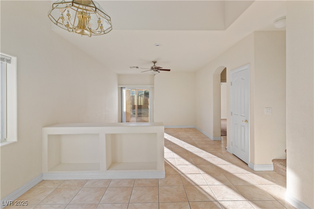 2715 Brinkley Manor Street Laughlin, NV 89029 - Photo 12 of 89 Dining area with light tile patterned floors and hanging light fixture and Living room in the background