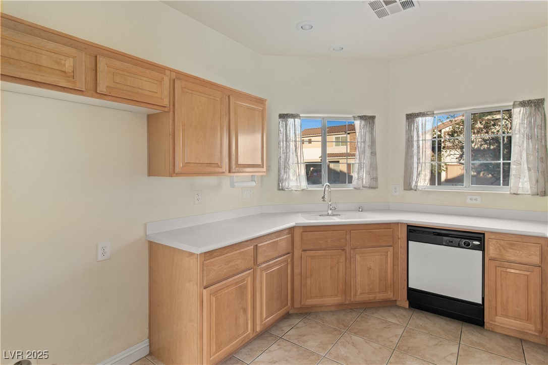 2715 Brinkley Manor Street Laughlin, NV 89029 - Photo 13 of 89 Kitchen with white dishwasher, light countertops, and light tile patterned floors