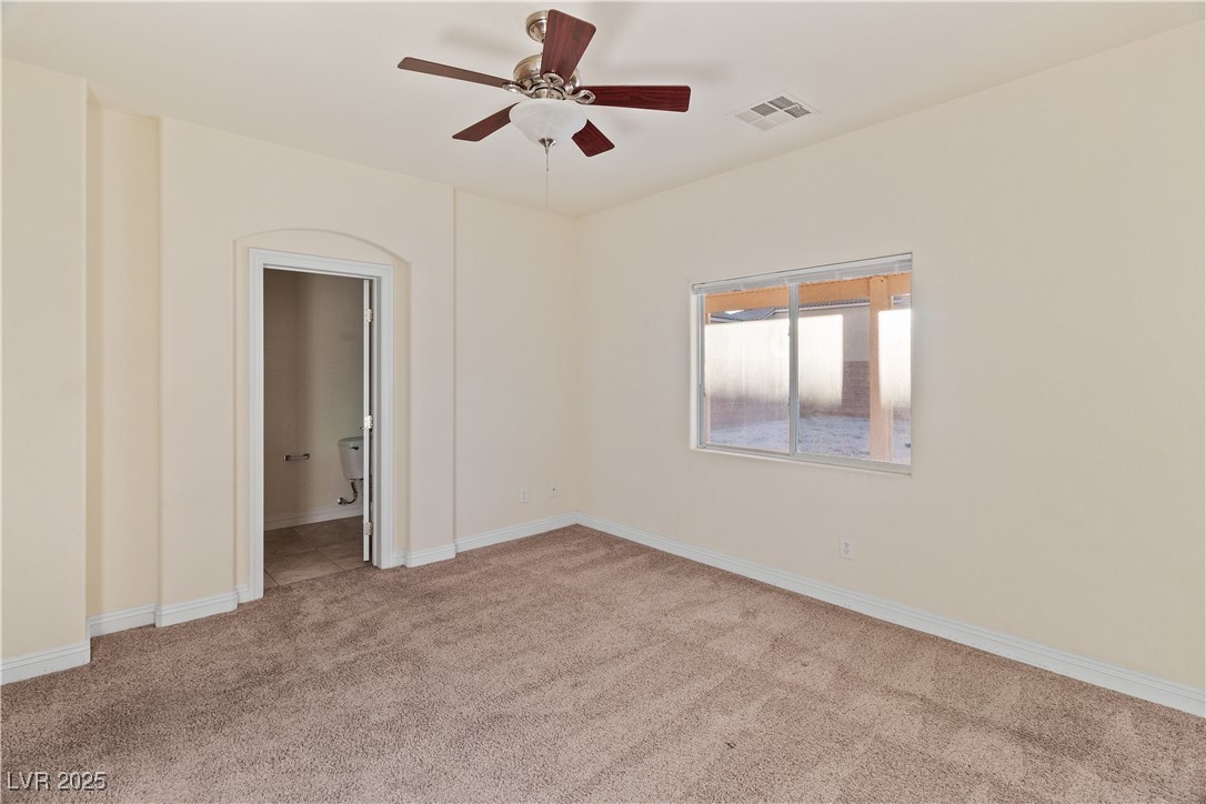 2715 Brinkley Manor Street Laughlin, NV 89029 - Photo 23 of 89 Primary Bedroom with light colored carpet and a ceiling fan