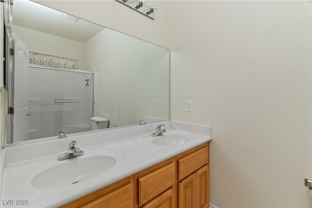 2715 Brinkley Manor Street Laughlin, NV 89029 - Photo 26 of 89 Full Ensuite Primary Bathroom with double vanity and a shower with door