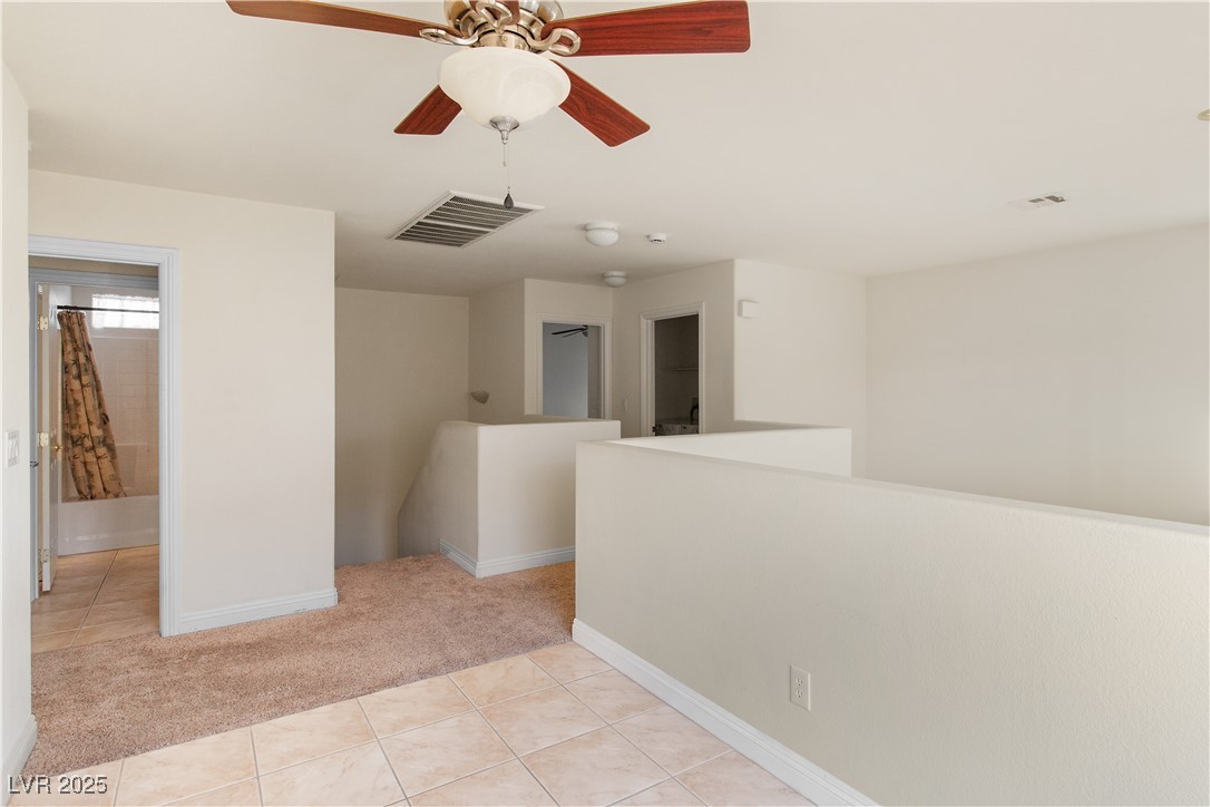 2715 Brinkley Manor Street Laughlin, NV 89029 - Photo 28 of 89 Upstairs loft with light tile patterned flooring, and light colored carpet leading into the 3 upstairs bedrooms