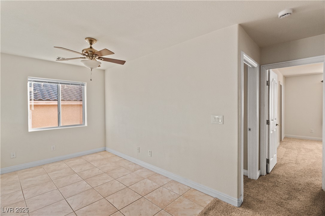 2715 Brinkley Manor Street Laughlin, NV 89029 - Photo 30 of 89 Upstairs loft featuring ceiling fan, light tile patterned floors, and light carpet leading into the bedrooms